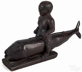 Carved pine figure of a man riding a fish, initialed ADS Mar 62, 13 1/2'' l.