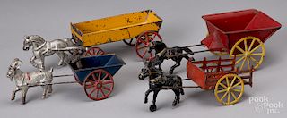 Four cast iron animal drawn wagons