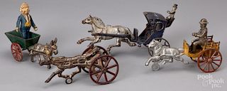 Four cast iron animal drawn wagons