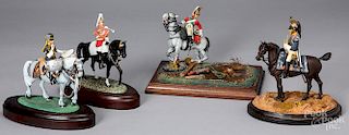 Four painted cast model soldiers on horseback