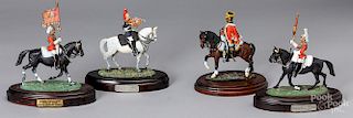 Four painted cast model soldiers on horseback