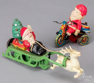 Two celluloid wind-up Santa Claus toys