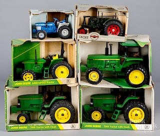 Four boxed Ertl John Deere die cast tractors, etc.