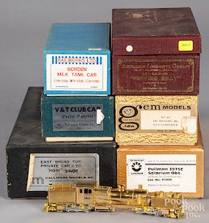Seven brass HO scale train cars and locomotives