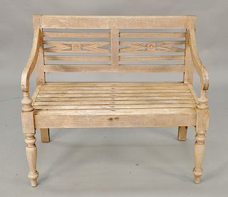 Teak outdoor bench with flower carvings set on turned legs. lg. 39 in.