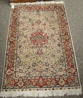 Two piece lot to include silk throw rug (2'8" x 4') and an Oriental throw rug (3'6" x 6'4").