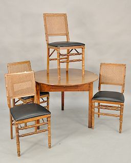 Mahogany folding table set including four faux with bamboo chairs and table. ht. 28 in., dia. 37 in.  Provenance: An Estate from Far...
