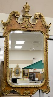George II style giltwood and walnut mirror surmounted by a scrolled crest and flame-form finial. ht. 53 in., wd. 29 in. Provenance: ...