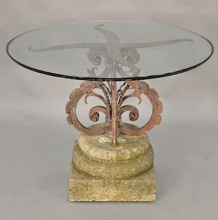 Iron pedestal on cement base with round glass top, late 19th to early 20th century. ht. 30 in., dia. 40 in. Provenance: From the Est...