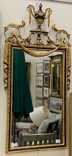 Gilt decorated mirror with urn and swag. 46" x 23" Provenance: An Estate from Farmington, Connecticut