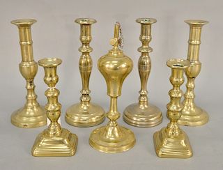 Seven piece to include three paris of brass candlesticks (including a pair of push up candlesticks) and an oil lamp. ht. 7 1/2 in. t...