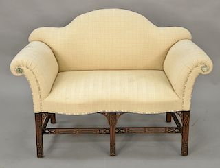 George III style upholstered mahogany settee of serpentine top raised on fret carved legs. lg. 48 in. Provenance: From the Estate of...