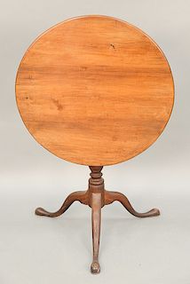 Federal cherry tip table on urn carved shaft on tripod base, 19th century. ht. 29 in., top: 29 1/4" x 29 3/4"