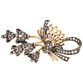 A diamond 14K yellow gold and silver brooch.