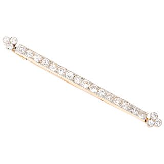 A diamond 18K and 14K yellow gold brooch.