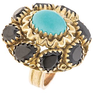 A turquoise and sapphire 14K yellow gold ring.