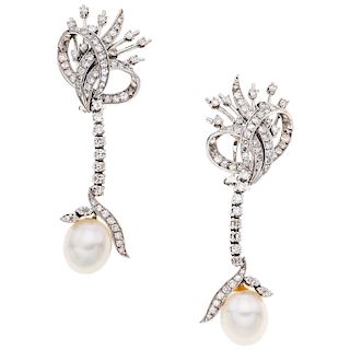 A cultured pearl and diamond palladium silver pair of earrings.