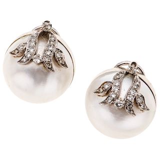 A half pearl and diamond 14K white gold pair of earrings.