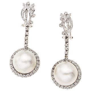 A half pearl and diamond palladium silver pair of earrings.