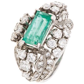 An emerald and diamond 18K white gold ring.