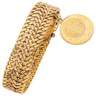 An 18K yellow gold bracelet with 21.6K yellow gold coin.