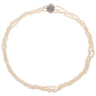 A cultured pearl necklace with a diamond 14K white gold clasp.
