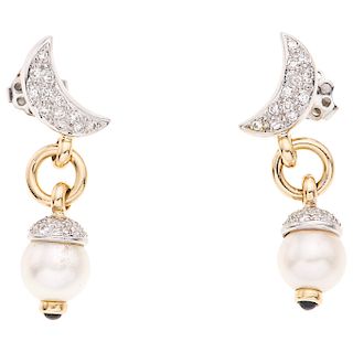 A cultured pearl, diamond and sapphire 14K white and yellow gold pair of earrings.
