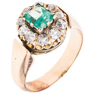 An emerald and diamond 14K rose gold ring.