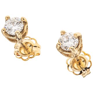 A diamond 14K yellow gold pair of stud earrings.
