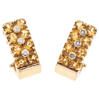 A citrine and diamond 14K yellow gold pair of earrings.