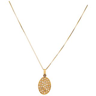 A diamond 14K yellow gold pendant and necklace.