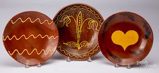 Three Breininger redware chargers