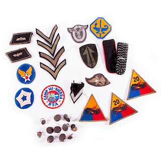 A collection of WWII badges and buttons.