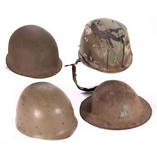 Four American WWII era helmets.
