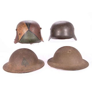 Four WWI and WWII era German and American helmuts.