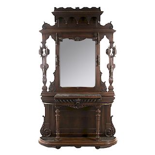 Perchero-paragüero. Francia. Siglo XX. En talla de madera de nogal. Con espejo de luna rectangular, 10 ganchos a manera de dragones.