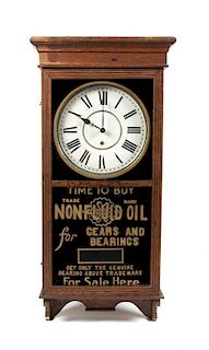 * An American Oak and Reverse Painted Advertising Wall Clock Height 38 x width 16 1/2 x depth 4 1/2 inches.
