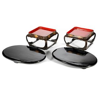 A pair of Japanese lacquered stands on stands.