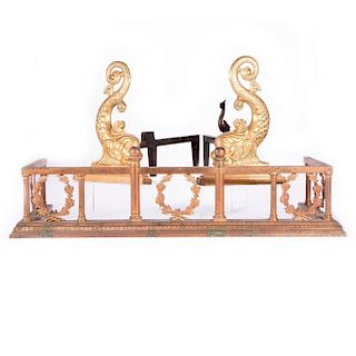 A brass and iron fireplace set with dolphin motif.