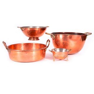 Four copper cooking vessels.