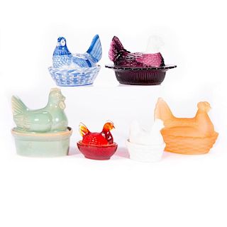 Six assorted porcelain and glass nesting chicken covered bowls.