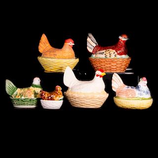 Six assorted porcelain and pottery covered nesting chicken bowls.