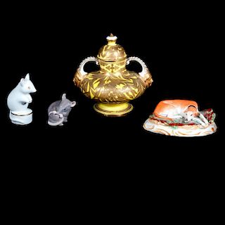 Three porcelain figures and a porcelain perfume jar.