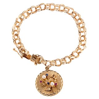 A Ladies Vintage Charm Bracelet in 14K Gold
