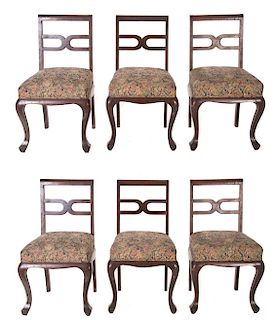 Lote de 6 sillas. SXX. En talla de madera. Con respaldos semiabiertos, asientos en tapicería floreada, fustes y soportes semicurvos.