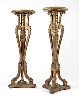 Two carved and giltwood pedestal stands