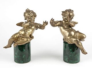 An opposing pair of gilt-bronze winged putti