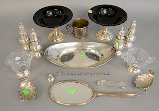 Sterling silver lot to include two pairs of salt and pepper shakers, two shell dishes, oval tray, and several weighted pieces.