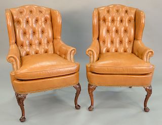 Pair of custom leather upholstered ladies wing chairs with tufted backs, ht. 42 in., wd. 29 in.