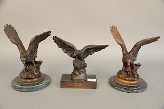Three bronze eagles, one marked Moigniez, ht. 10 3/4 in., 10 3/4 in., 8 3/4 in.